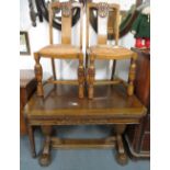 Extending table with two carved leather chairs