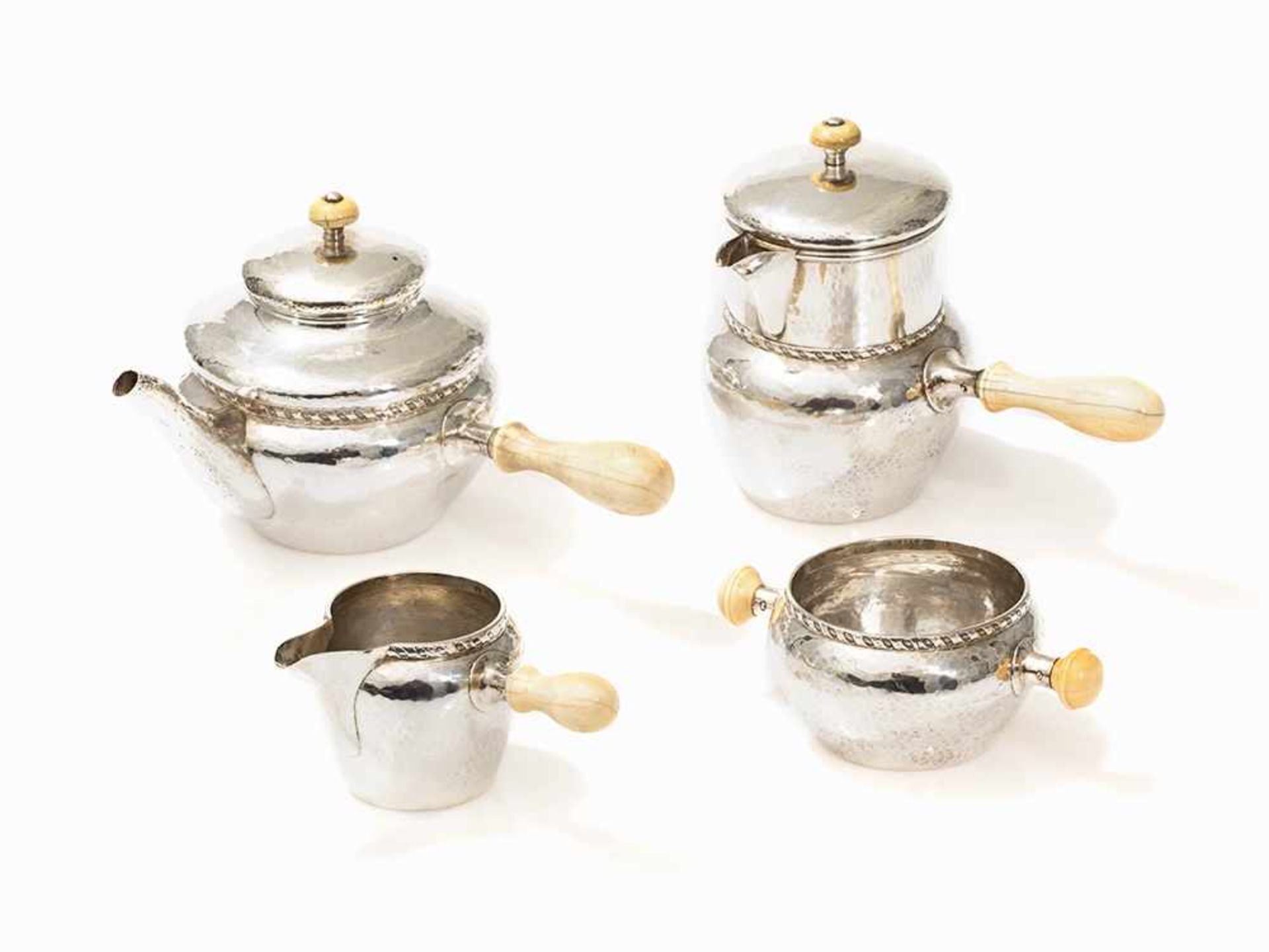 Albert E. Jones, 4-Piece Coffee and Tea Service, 1924/28 Cast, hammered and chased sterling