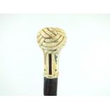 A LEATHER WALKING CANE, the marine ivory knop