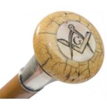 AN EARLY 20TH CENTURY MASONIC WALKING CANE, the ivory pommel inset with mother of pearl engraved