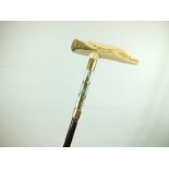 A 1920'S/30'S WALKING CANE, the ivory handle crudely carved as a naked female