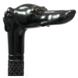 A CARVED EBONY WALKING STICK, the grip carved as a greyhound's head with inset glass eyes, the shaft