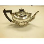 An Edwardian silver teapot, Chester 1910, maker's mark rubbed, of oval form embossed with