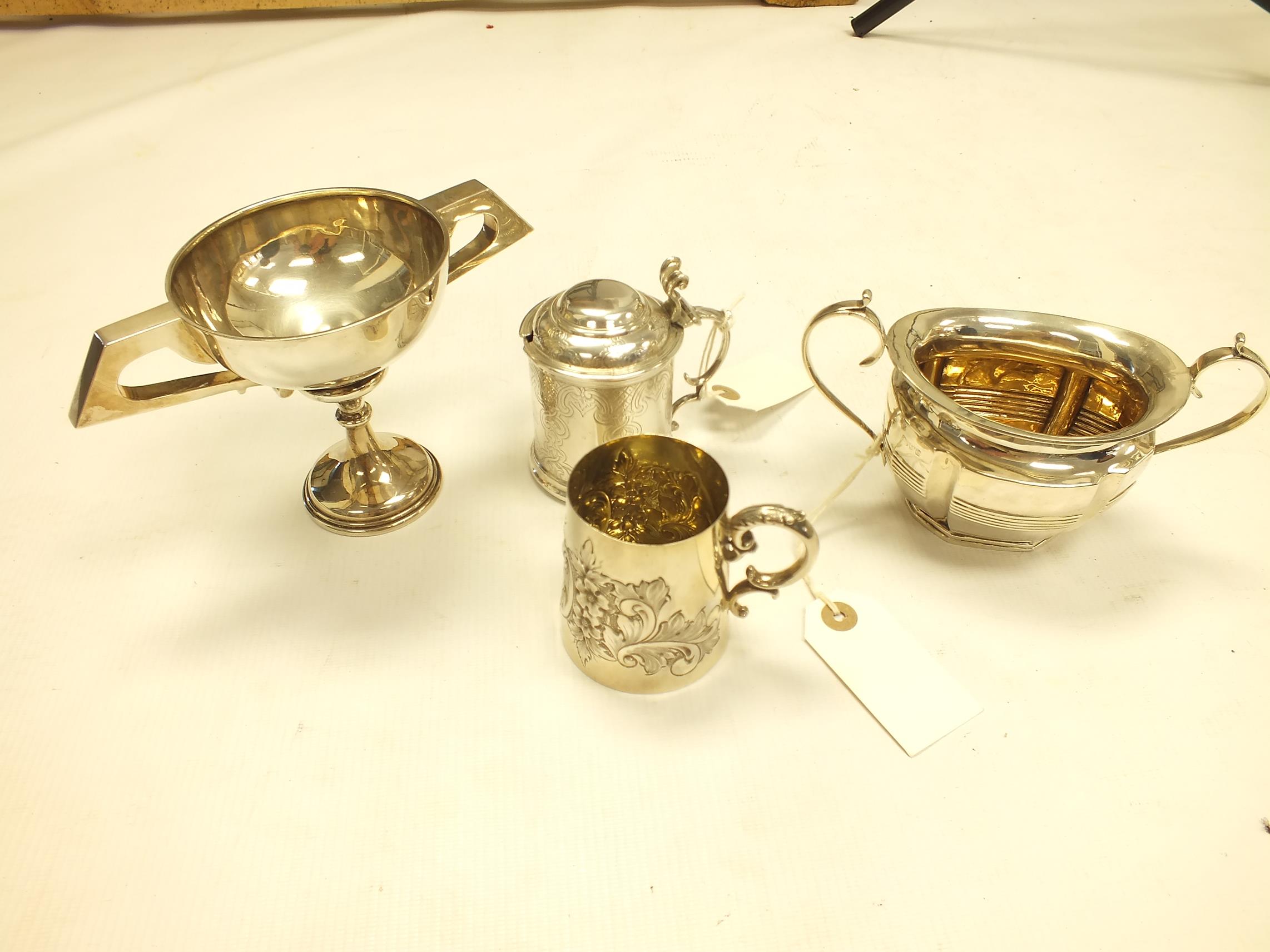 A silver small mug by Walker & Hall, Sheffield 1901, embossed with flowers and foliage and