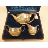 A Victorian silver three piece tea set by Charles Boyton, London 1894, of plain semi-gadrooned form,