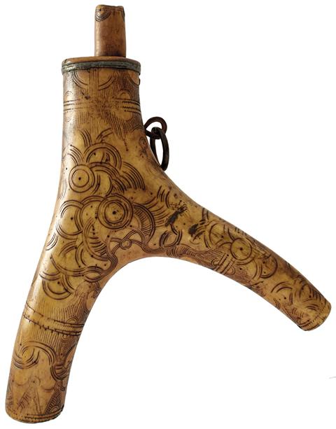 A 17TH CENTURY GERMAN POWDER FLASK, the two-branch stag horn body decorated with panels of geometric