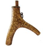 A 17TH CENTURY GERMAN POWDER FLASK, the two-branch stag horn body decorated with panels of geometric