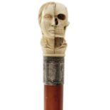 A LATE 19TH/EARLY 20TH CENTURY WALKING CANE, the ivory pommel carved as the head of a young woman,