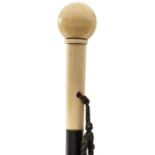 A LATE 19TH/EARLY 20TH CENTURY WALKING CANE, the ivory pommel of spherical form, above ivory