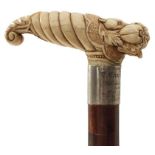 AN EARLY 20TH CENTURY WALKING STICK, the ivory handle carved as a cornucopia of fruits, above