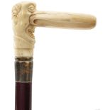 AN EARLY 20TH CENTURY WALKING STICK, the marine ivory handle carved as a gentleman with a large