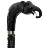 A CARVED EBONY WALKING STICK WITH ELEPHANT'S HEAD HANDLE, inset with bone dot decoration and foliate