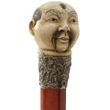 A 19TH CENTURY ORIENTAL SWORD STICK, the ivory pommel carved as the head of a gentleman with abalone