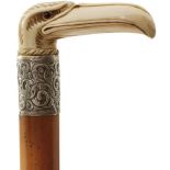 A LATE 19TH CENTURY WALKING STICK, the ivory handle carved as a stylised eagle's head, above white