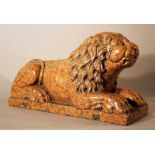 Italian rosso verona stone lion in sitting position, sculpted in naturalistic shape with some