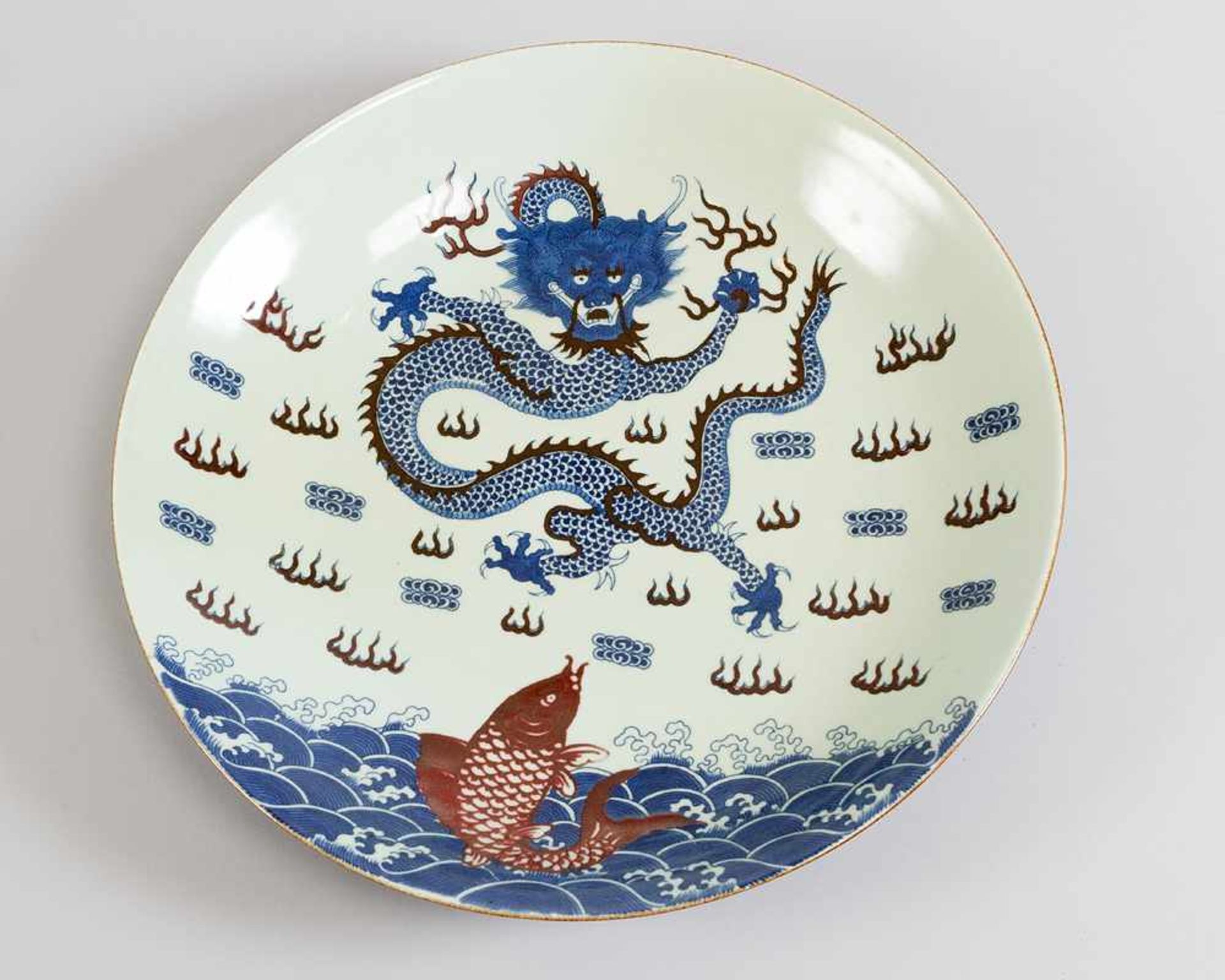 Chinese porcelain dish with painted blue and red dragon, fish and other decorations, on white