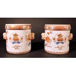 A pair of Compagnie des Indes porcelain pots, cylindrical shape with two grimaces faces on the