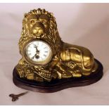 An eye turning clock in shape of a lying lion with enamel dial with Roman numbers; two fingers,