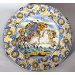 A Castelli majolica dish with wide border with coloured painted flowers, in the centre a charriot