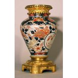 Imari porcelain vase in conical shape; with blue, red and gilded floral paint on white ground,