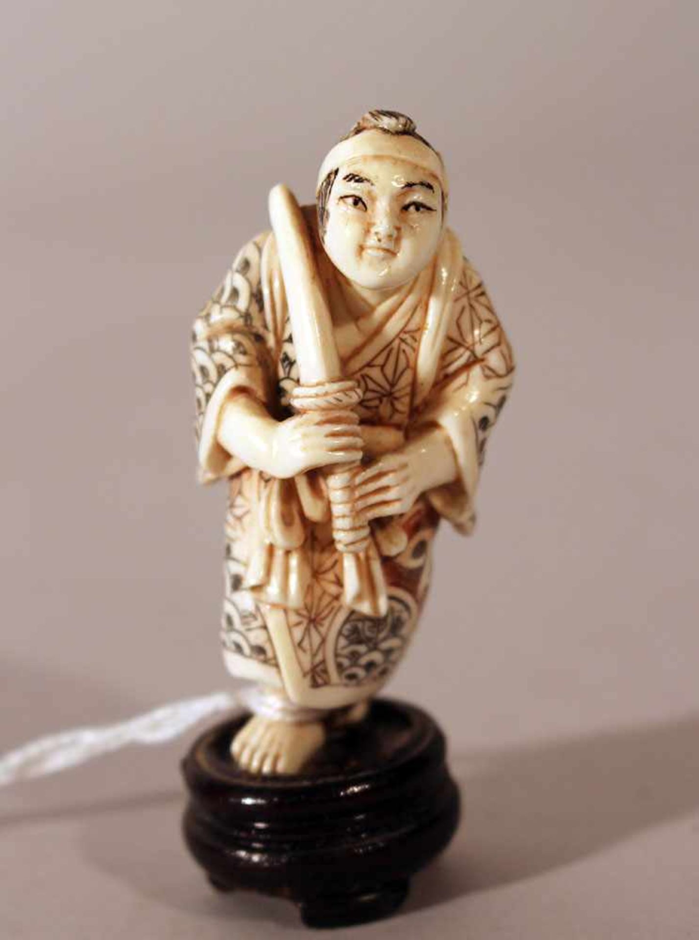 Japanese ivory netsuke, warrior with sword; very fine carvings with black and brown engravings, on