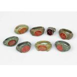 Collection of eight gemstone rings in ancient manner, each with red cutted gemstone with different