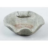 Small stone basin in shape of a shell with waved border and scrolls. Possibly granit, around 1900.