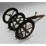 Model of an archaic plow with four open work wheels on central connection with two branches ending