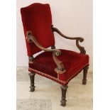 Arm chair in Baroque Style on four carved legs, with curved arm rest, with red velvet pillows and