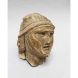 Male Stone Head of a roman soldier with helmet and face protection, parts missing, the helmet