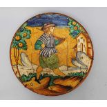 Montelupo ceramic dish, round shape with painted ornament of young man in landscape with houses,