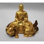 Chinese gilted bronze sculpture of Buddha in sitting position with falted mantle and his hands