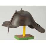 Iron Helmet, round shape with a front blend and visor, on the reverse four iron blades for neck