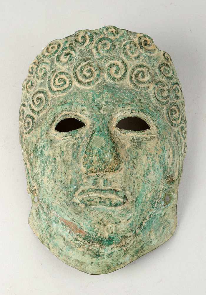 Ancient Copper Mask, of a man with curly hair, open work eyes, with two holes for fixation,