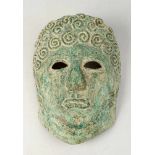 Ancient Copper Mask, of a man with curly hair, open work eyes, with two holes for fixation,