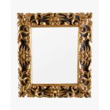 Florintine Mirror in manieristic manner with bride border and decorated with carved volutes and