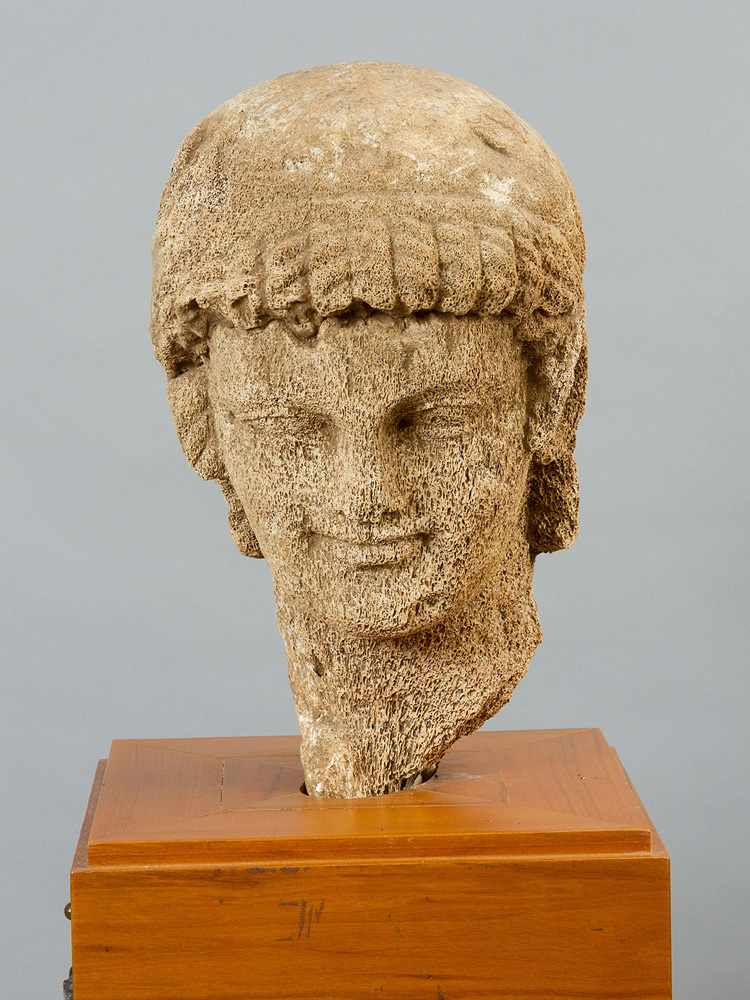 Stoned Wooden or Bone Head, in ancient style of a male youth with fine sculpted profile and curled