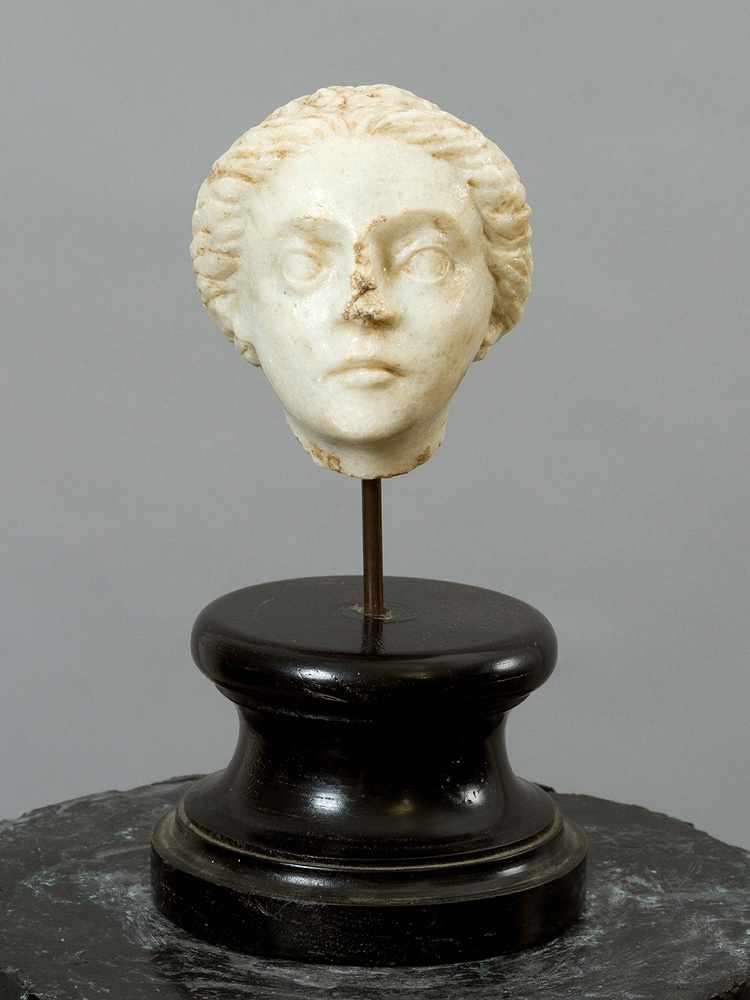 Female Marble Head in Ancient Style, with naturalistic sculpted face partly waved hair, on later