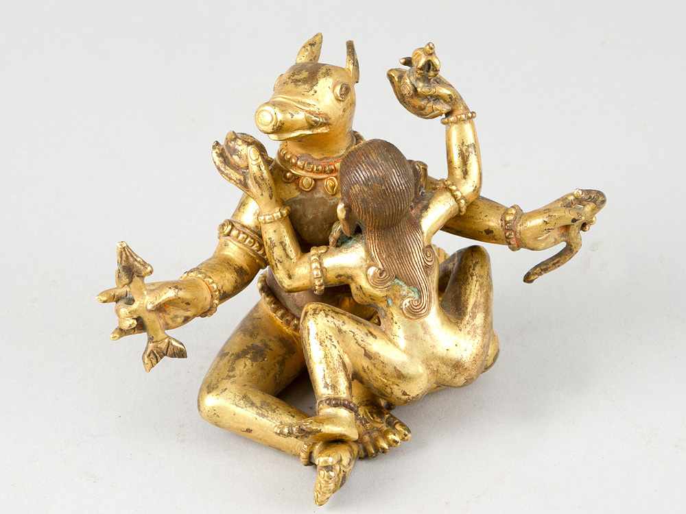 Indian erotic bronce sculpture, of a female and male godness with several objects in hands and the