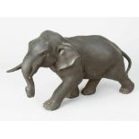 Asian Bronze Elephant, in moving position, bronze cast with dark patina, on the other side signed in