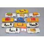 Twelve unboxed diecast taxi models in 1:43 scale, including examples by Corgi, Dinky,