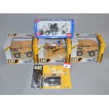 Three boxed CAT Construction Vehicles including two 797F Dump Trucks in 1:101 scale and a D11T