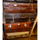 Five vintage suitcases, well used.
