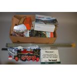 A mixed lot containing a plastic G gauge train, various pieces of track, catalogues, etc.