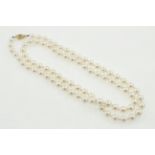A single row of cultured pearls, clasp stamped 14k, total lenght 25.