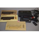 A quantity of unboxed vintage gaming items including 2 x Commodore 64, a Sega Master System II,