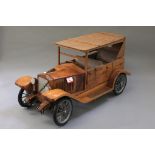 A large wooden model of a Vintage Car, approximately 80cm in length,