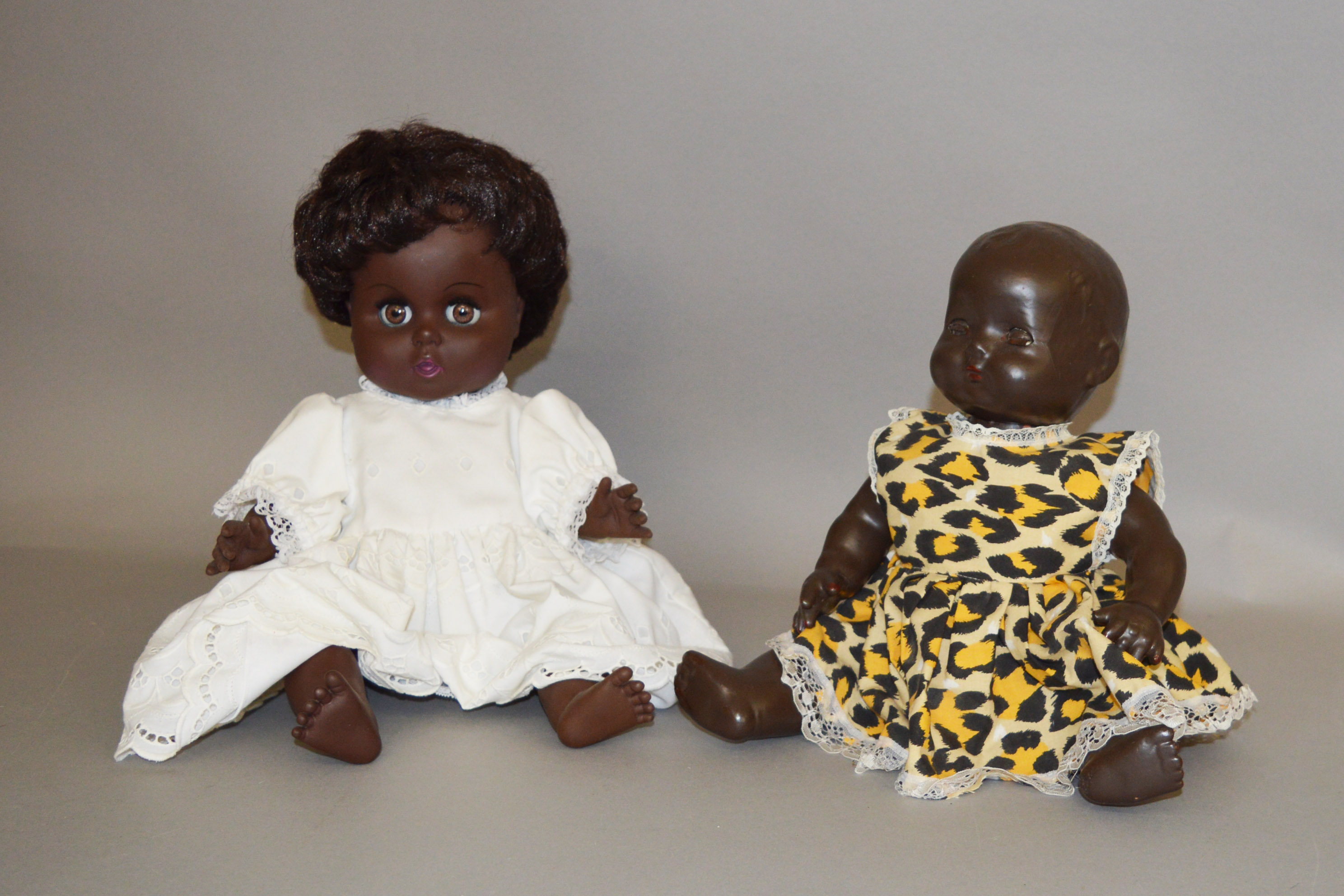 Two black dolls: Rosebud hard plastic doll; Mick Graham vinyl doll.