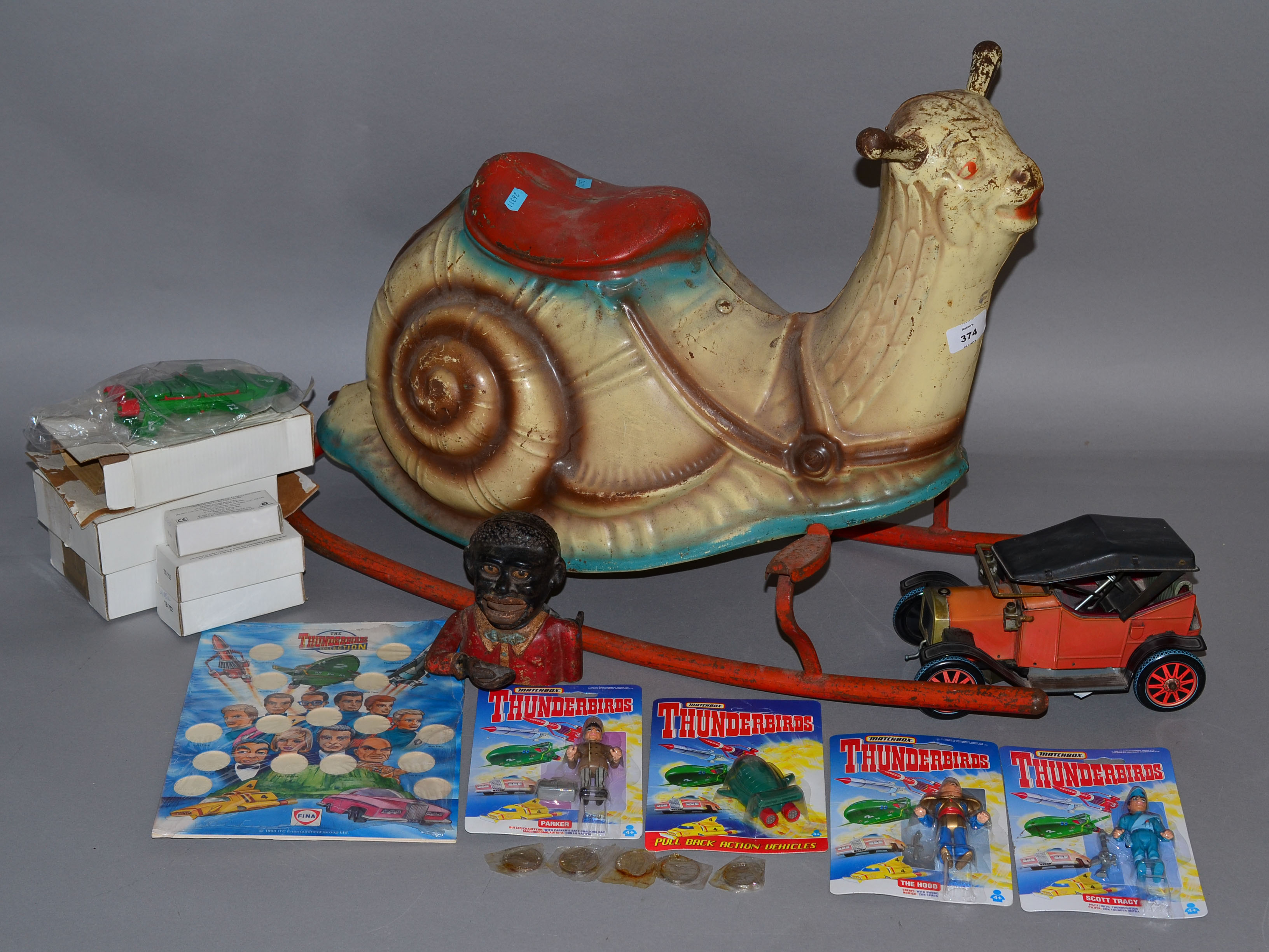 A mixed lot: Mobo Rocking Snail; Jolly cast money bank; tinplate car;