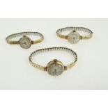 Three manual wind ladies 9 carat wristwatches, all on expandable metal bracelets,